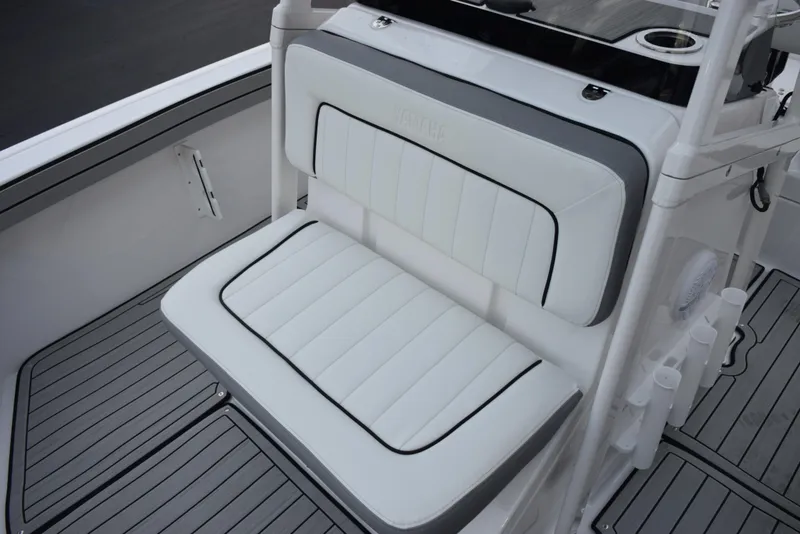 Slide: The Image of 2025 Yamaha Boats 195 FSH Sport interior seating with white and gray upholstery. - 11