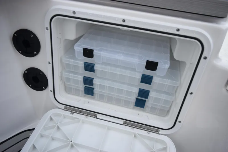 Slide: The Image of Storage compartment with tackle boxes on 2025 Yamaha Boats 195 FSH Sport. - 15