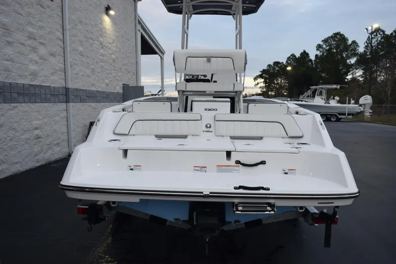 Slide: The Image of 2025 Yamaha Boats 195 FSH Sport, rear view, parked outdoors near a building. - 5