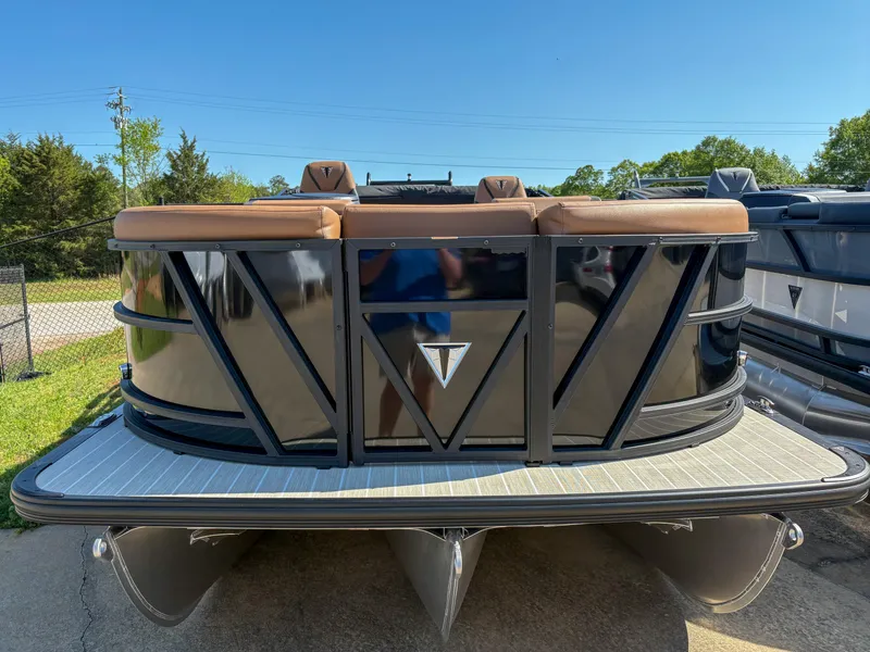 Slide: The Image of 2025 Trifecta 23 RF SS pontoon boat with sleek black design and tan seating. - 2