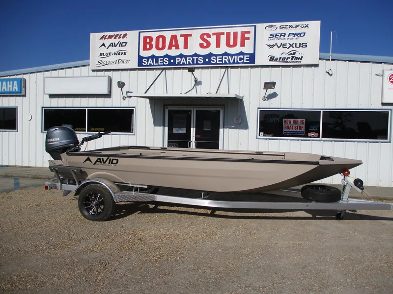 Slide: The Image of 2025 Avid 18 Commander boat on trailer outside dealership. - 0