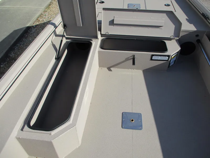 Slide: The Image of 2025 Avid 18 Commander boat interior with open storage compartments. - 10