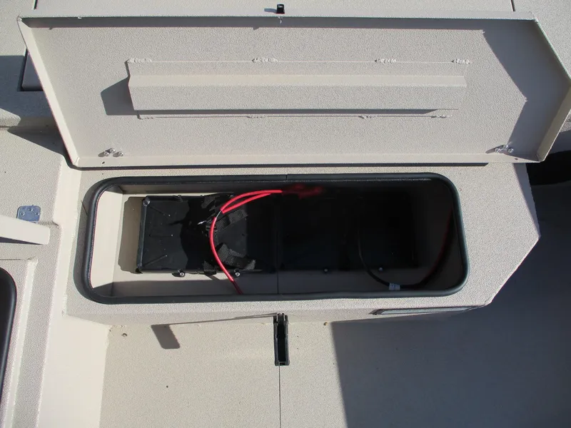 Slide: The Image of Avid 18 Commander 2025 boat storage compartment with battery and wiring. - 11