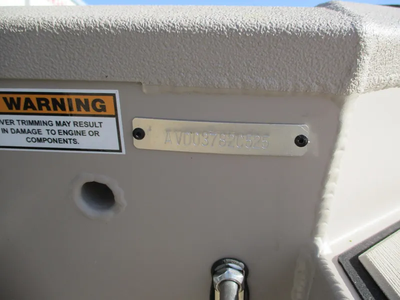 Slide: The Image of Avid 18 Commander 2025 boat identification plate with warning label. - 14