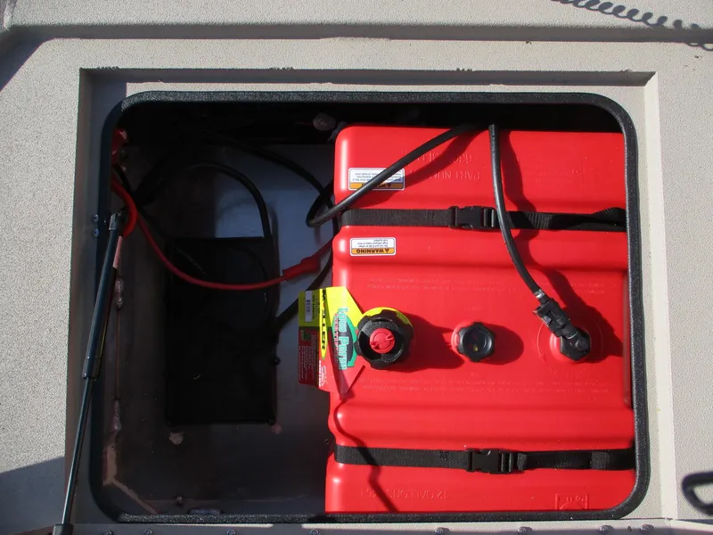 Slide: The Image of 2025 Avid 18 Commander boat fuel tank compartment with red fuel tanks and wiring. - 9