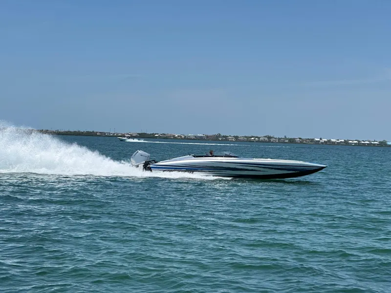 Slide: The Image of 2025 Fountain 34 Thundercat speedboat cruising on open water, creating a dynamic wake. - 5