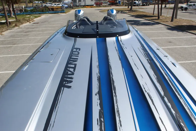 Slide: The Image of 2025 Fountain 34 Thundercat boat with sleek design and blue accents in a parking lot. - 8