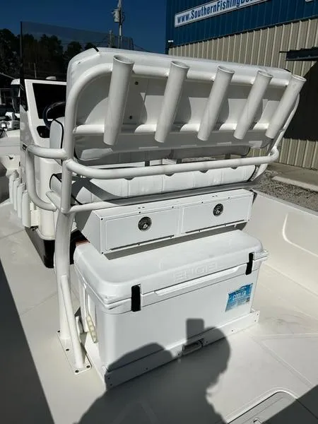Slide: The Image of 2024 Skeeter SX230 boat with rod holders and storage compartments, displayed outdoors. - 10