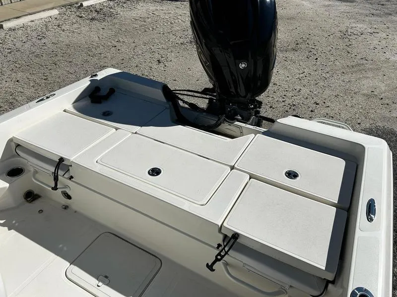 Slide: The Image of 2024 Skeeter SX230 boat deck with storage compartments and outboard motor. - 11