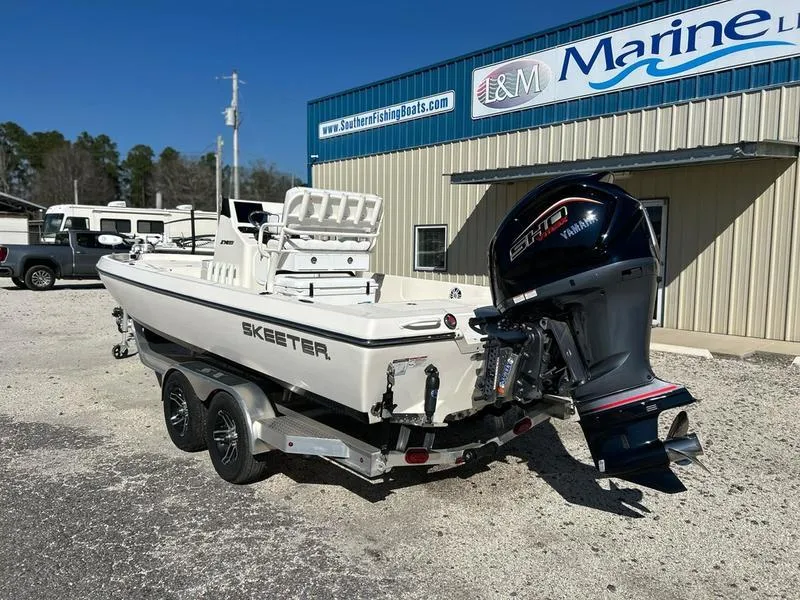 Slide: The Image of 2024 Skeeter SX230 boat with Yamaha engine on trailer outside marine shop. - 4