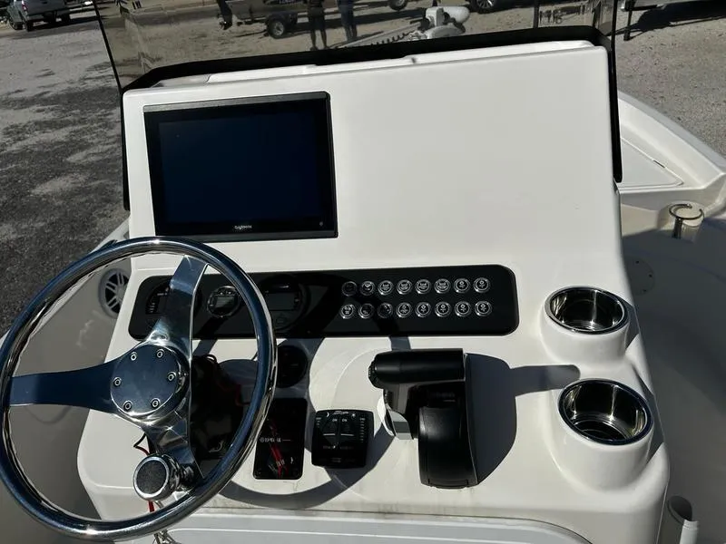 Slide: The Image of 2024 Skeeter SX230 boat dashboard with steering wheel, controls, and display screen. - 6