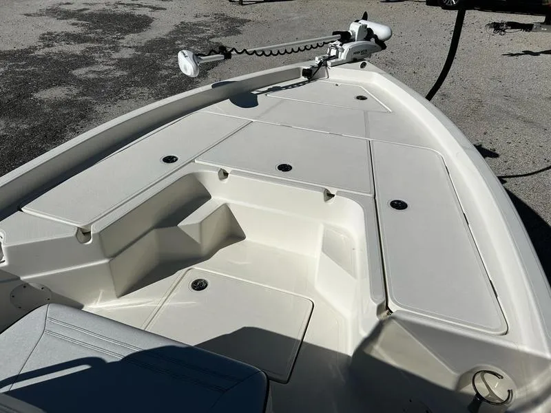 Slide: The Image of 2024 Skeeter SX230 boat deck with storage compartments and trolling motor. - 9
