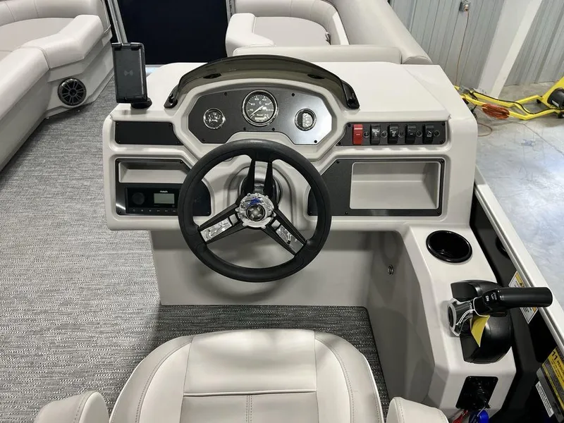 Slide: The Image of 2025 Godfrey Xperience 2086 CX boat dashboard with steering wheel and control panel. - 10