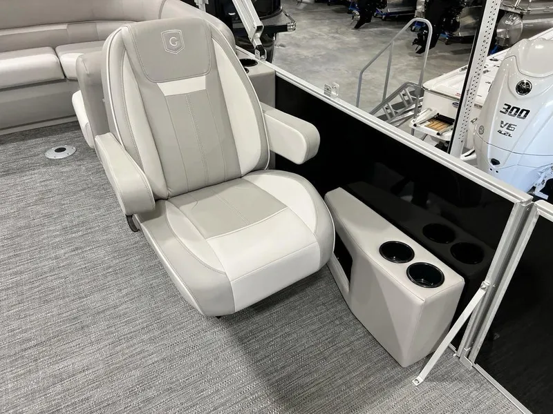 Slide: The Image of Captain's chair on 2025 Godfrey Xperience 2086 CX boat, with cup holders and modern design. - 7