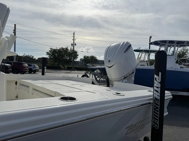Slide: The Image of 2025 Pathfinder 2600 TRS boat with outboard motor in a parking lot. - 4