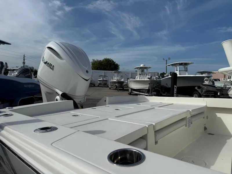 Slide: The Image of 2025 Pathfinder 2600 TRS boat with Yamaha engine, docked under a clear sky. - 7