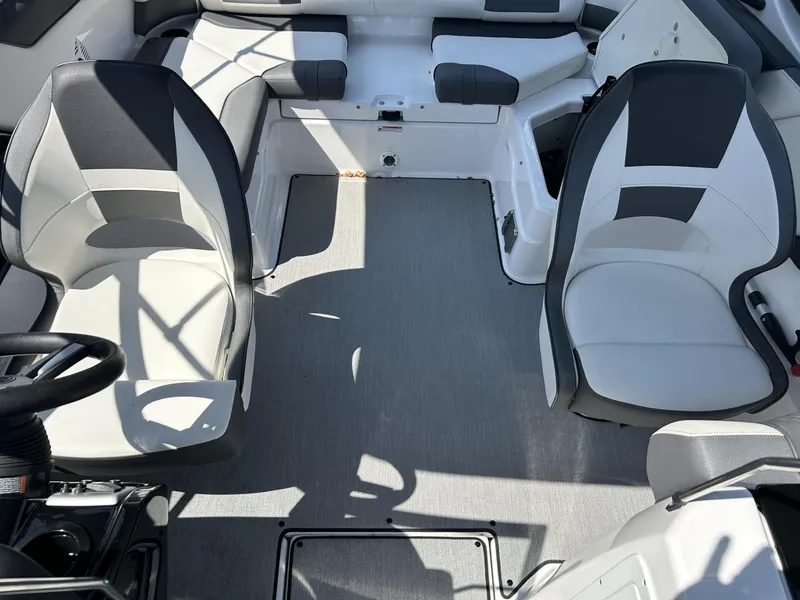 Slide: The Image of Interior of a 2021 Yamaha Boats SX 210, featuring sleek seating and modern design. - 8
