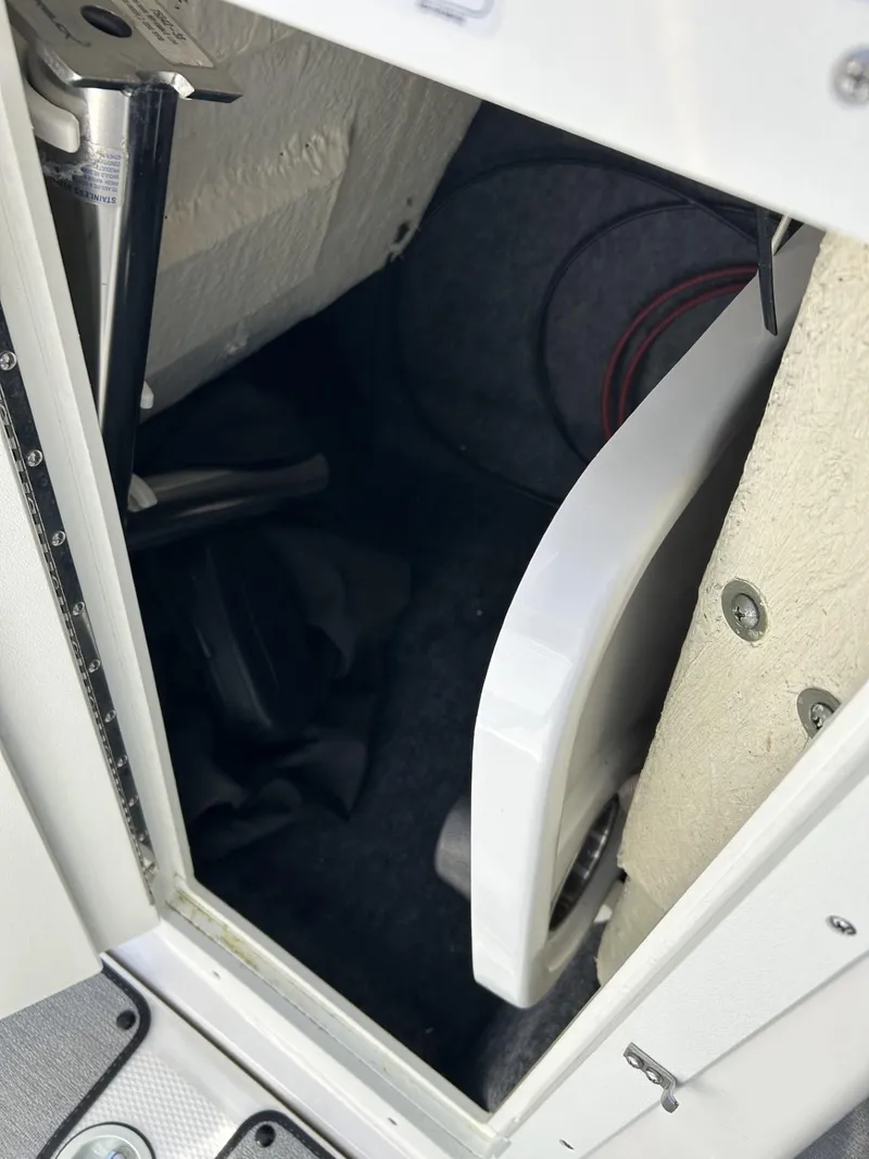 Slide: The Image of Storage compartment in a 2021 Yamaha Boats SX 210, showing interior details. - 9