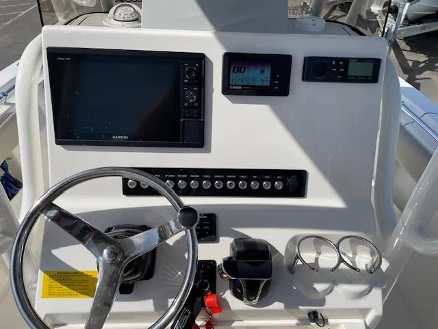 Slide: The Image of 2021 Key West 239 FS boat dashboard with steering wheel and electronic controls. - 13