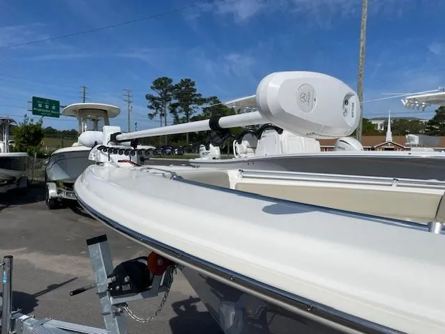 Slide: The Image of 2021 Key West 239 FS boat with trolling motor, parked outdoors under clear sky. - 20