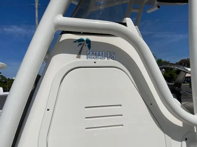Slide: The Image of 2021 Key West 239 FS boat console with logo and palm tree graphic. - 4