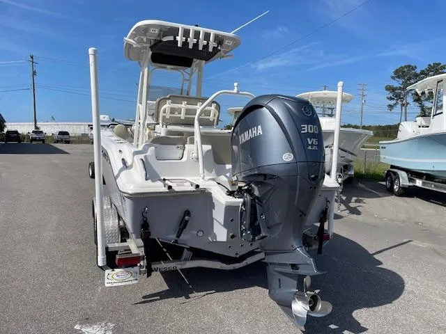 Slide: The Image of 2021 Key West 239 FS boat with Yamaha 300 V6 engine, parked outdoors. - 9