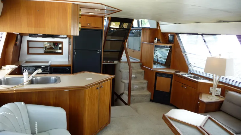 Slide: The Image of Interior of 1995 Bayliner 4788 Pilot House Motoryacht with wood cabinetry and modern amenities. - 11