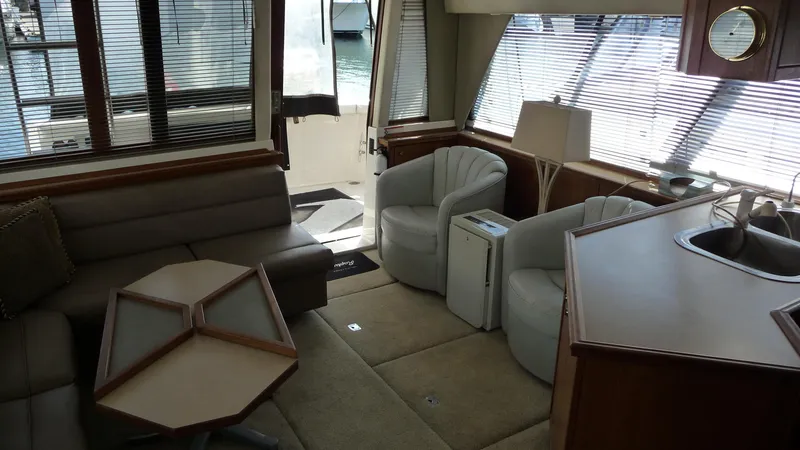 Slide: The Image of Interior of 1995 Bayliner 4788 Pilot House Motoryacht with seating, table, and windows. - 14