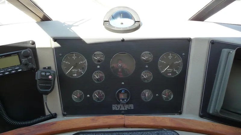 Slide: The Image of 1995 Bayliner 4788 Pilot House Motoryacht dashboard with gauges and radio equipment. - 23