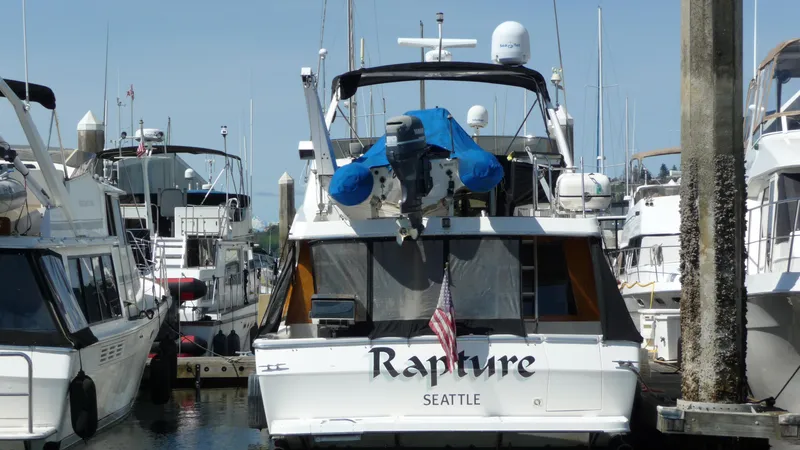 Slide: The Image of 1995 Bayliner 4788 Pilot House Motoryacht docked in marina, named "Rapture," Seattle. - 3