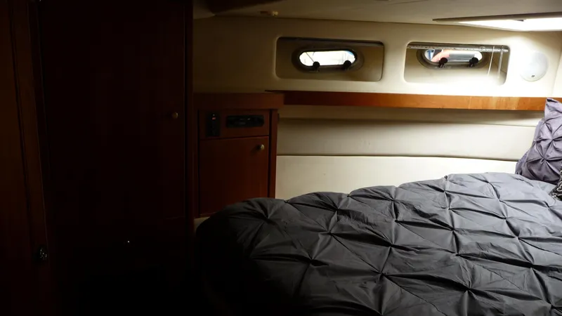 Slide: The Image of Cozy bedroom interior of 1995 Bayliner 4788 Pilot House Motoryacht with porthole windows. - 33