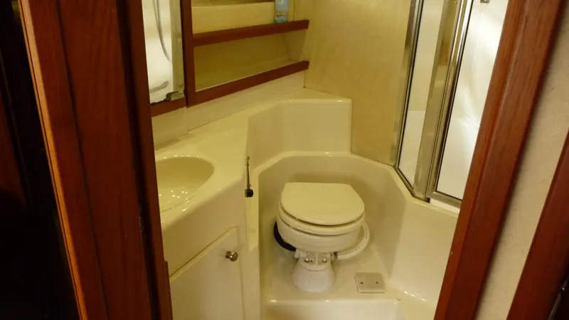 Slide: The Image of Bathroom interior of 1995 Bayliner 4788 Pilot House Motoryacht, featuring toilet and shower. - 35
