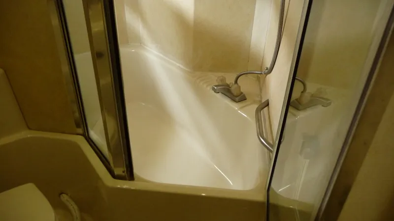 Slide: The Image of Bathroom with corner shower in 1995 Bayliner 4788 Pilot House Motoryacht. - 37