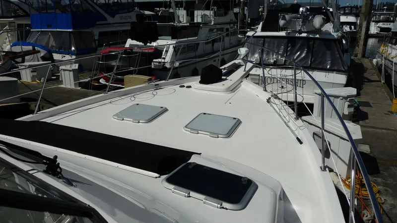 Slide: The Image of 1995 Bayliner 4788 Pilot House Motoryacht docked, showcasing deck and hatches. - 4