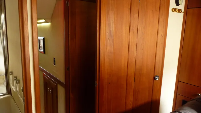 Slide: The Image of Interior of 1995 Bayliner 4788 Pilot House Motoryacht with wooden cabinetry and hallway. - 40