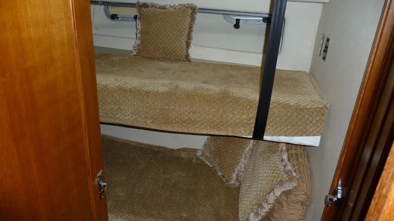 Slide: The Image of Bunk beds in 1995 Bayliner 4788 Pilot House Motoryacht cabin with beige bedding. - 41