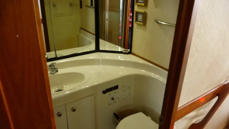 Slide: The Image of 1995 Bayliner 4788 Pilot House Motoryacht bathroom with sink, mirror, and toilet. - 46