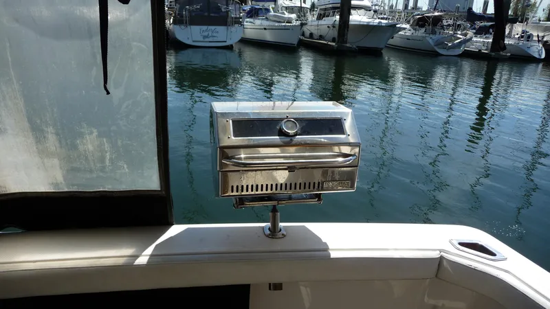 Slide: The Image of 1995 Bayliner 4788 Pilot House Motoryacht with stainless steel grill on deck, docked at marina. - 9