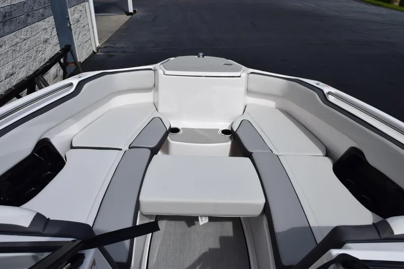 Slide: The Image of 2025 Yamaha Boats AR250 interior with sleek white seating and modern design. - 15