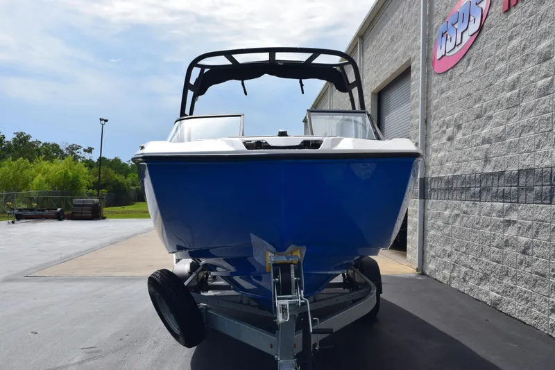 Slide: The Image of 2025 Yamaha Boats AR250 in blue, parked on a trailer outside a building. - 3