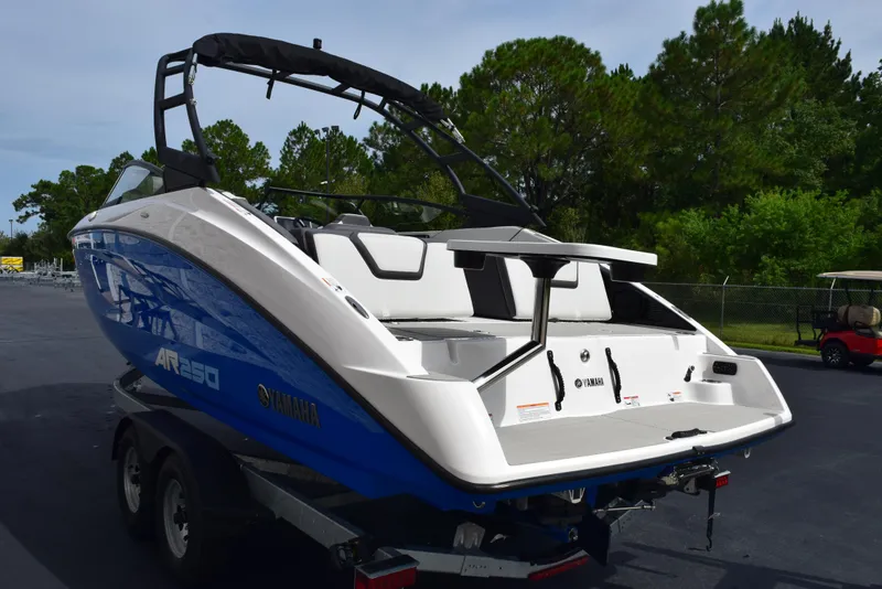 Slide: The Image of 2025 Yamaha AR250 boat on trailer, featuring sleek design and blue accents. - 6