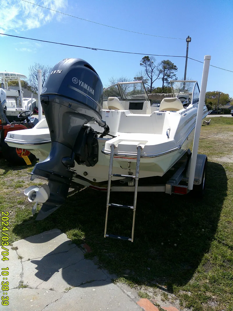 Slide: The Image of 2019 Stingray 191 Dual Console boat with Yamaha outboard motor, parked on trailer. - 10