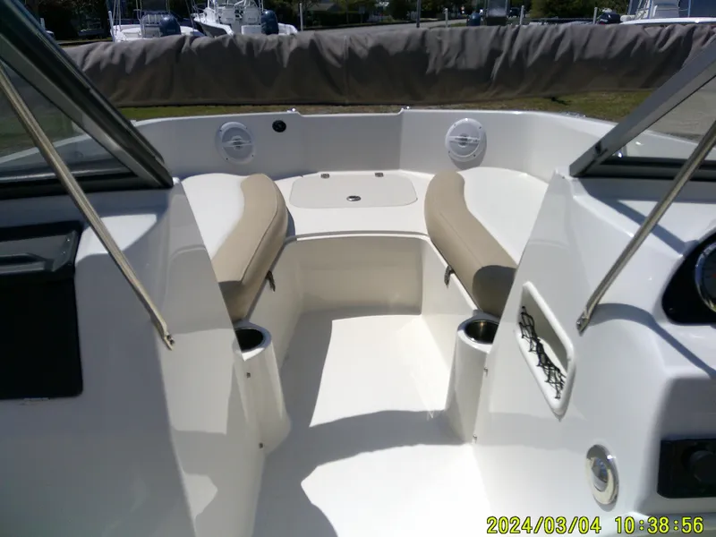 Slide: The Image of 2019 Stingray 191 Dual Console boat interior with seating and cup holders. - 11