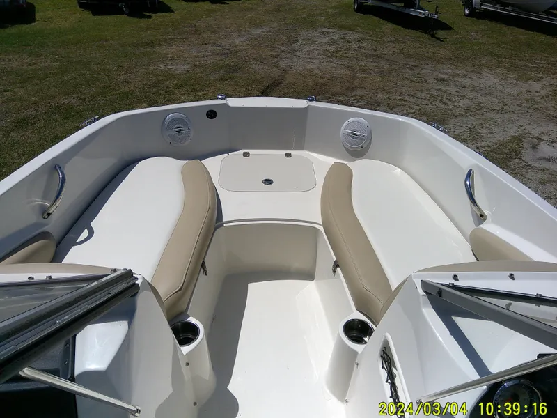 Slide: The Image of 2019 Stingray 191 Dual Console boat interior with beige seating and cup holders. - 13