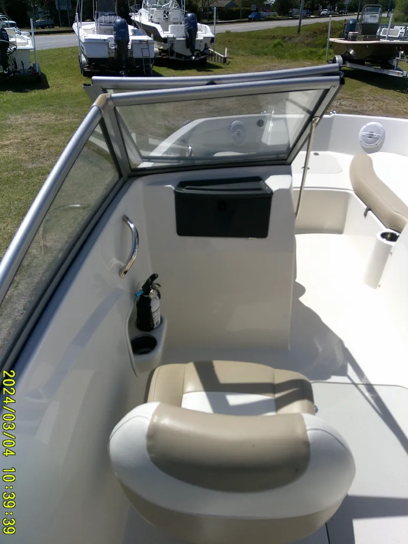 Slide: The Image of 2019 Stingray 191 Dual Console boat interior with seating and windshield. - 16