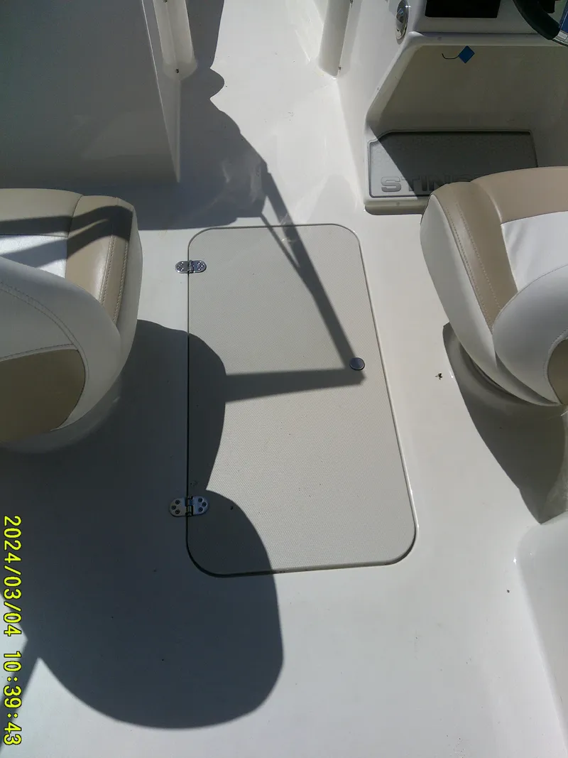 Slide: The Image of 2019 Stingray 191 Dual Console interior with beige and white seating. - 17
