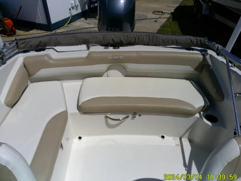 Slide: The Image of 2019 Stingray 191 Dual Console boat interior with beige seating and white deck. - 20