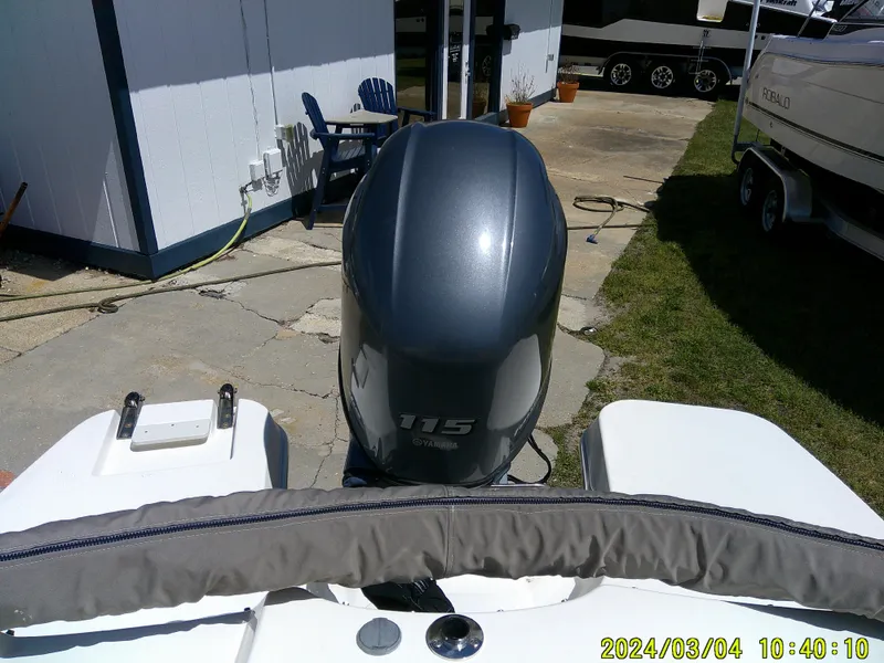 Slide: The Image of 2019 Stingray 191 Dual Console boat with 115 horsepower engine, docked outdoors. - 21