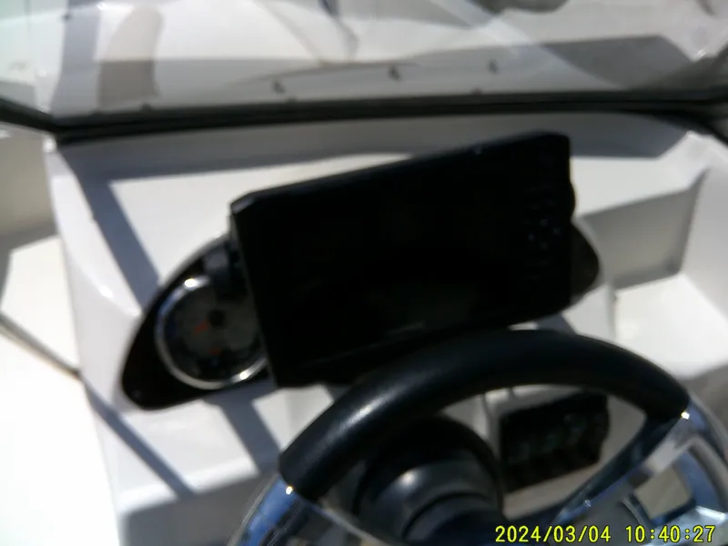 Slide: The Image of Dashboard of a 2019 Stingray 191 Dual Console boat with steering wheel and display. - 22