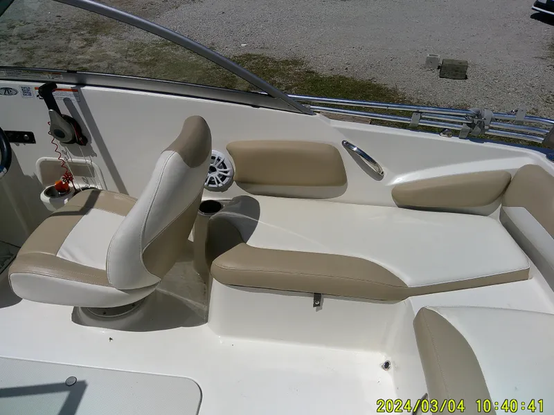 Slide: The Image of 2019 Stingray 191 Dual Console boat interior with beige and white seating. - 23